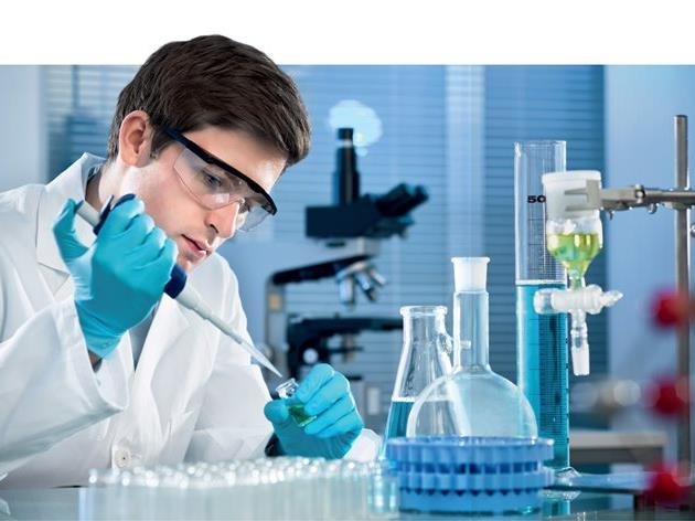 guy with glasses working with pipe in a chemical laboratory